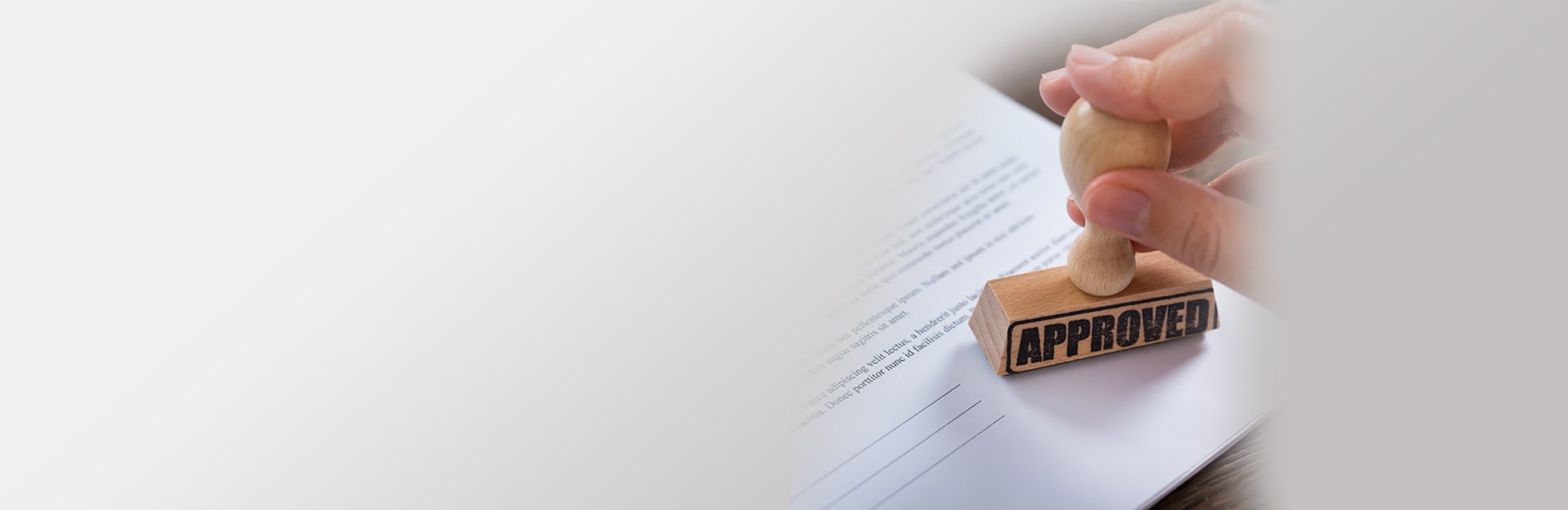 Man Stamping With Approved Stamp On Document