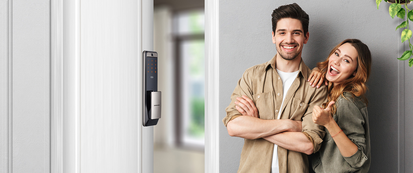 Man and woman in front of door with smart lock