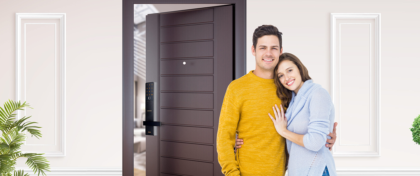 Man and woman in front of door with smart lock