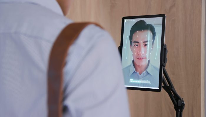 Facial,Recognition,Concept,-,Asian,Businessman,Using,Face,Scanner,To