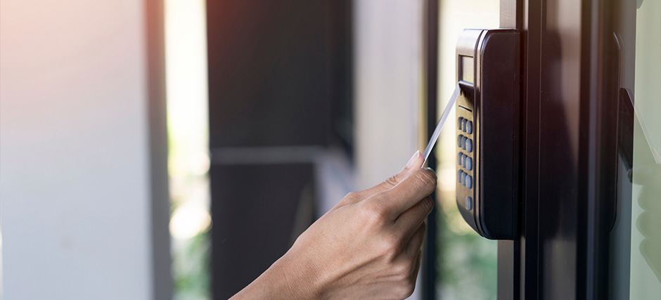 Person tapping RFID Card on access control panel