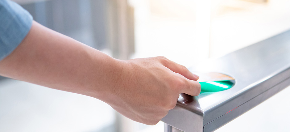 Person using security carf to open gate