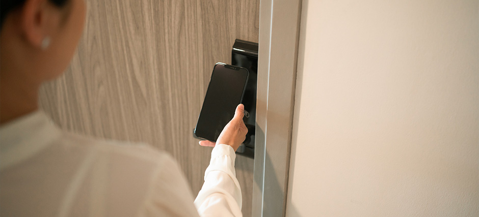 Woman using phone to unlock door