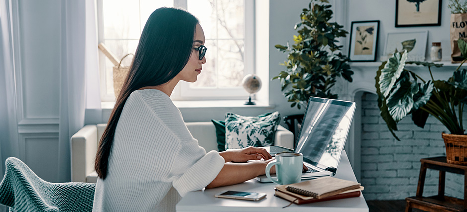 Person working on a laptop in a home office.